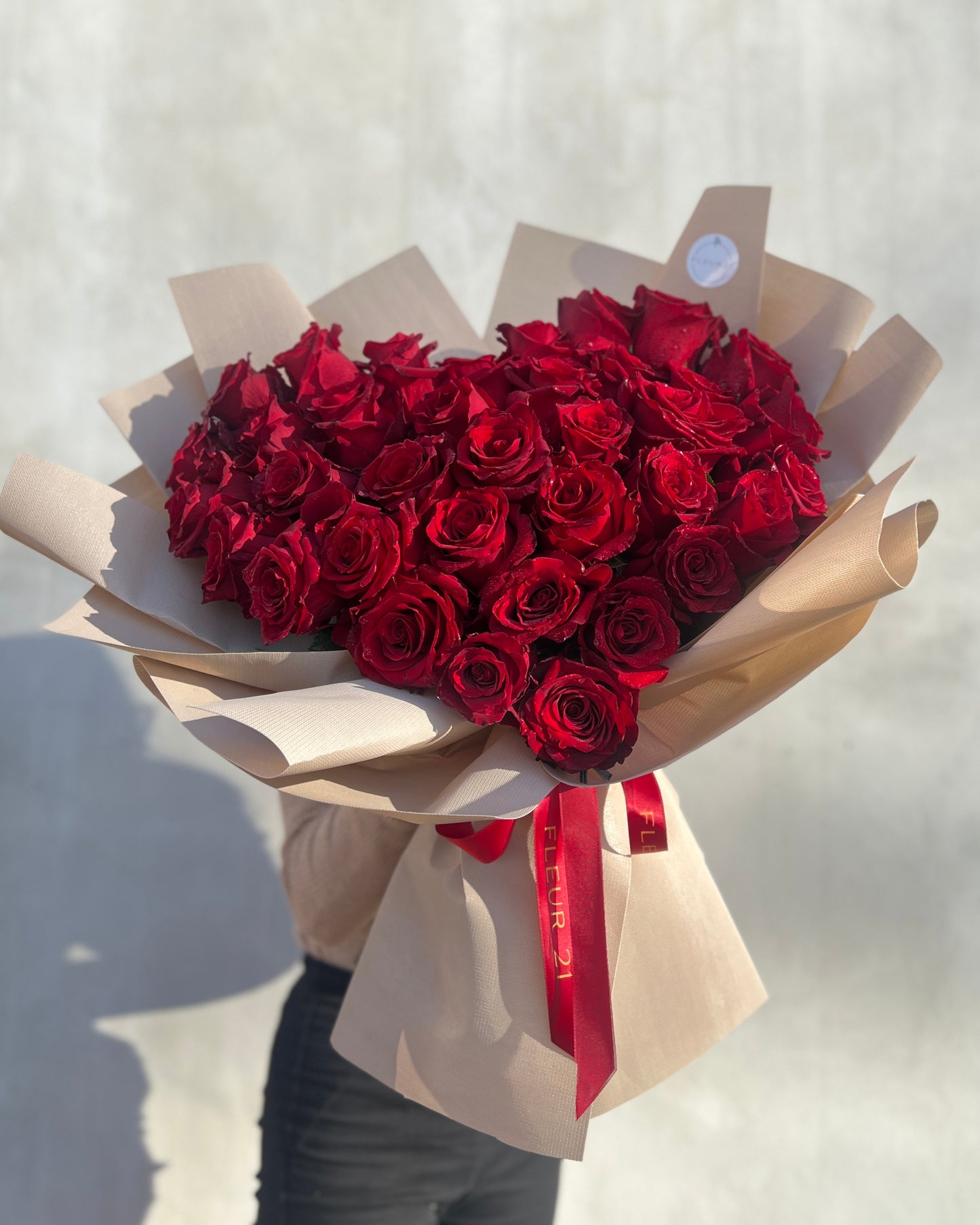 Red roses in the shape of a heart in paper
